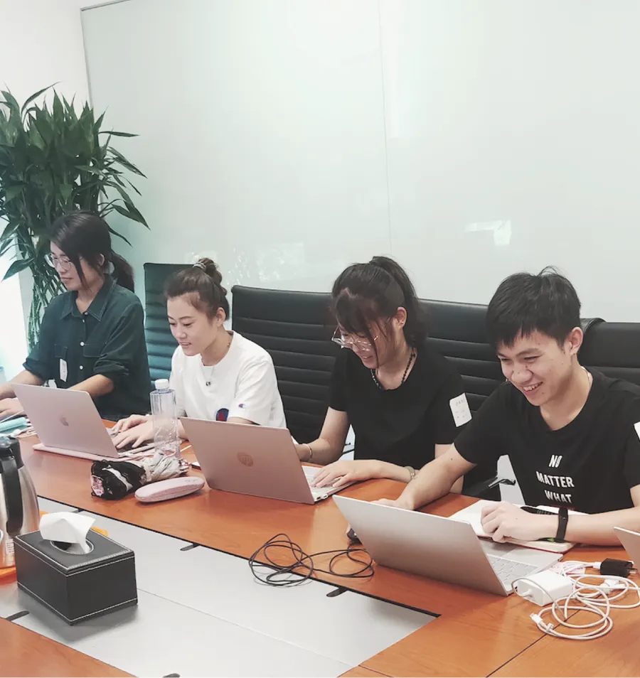 Team members conducting a user interview at a laptop